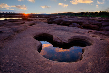 The stone hole form like Mickey Mouse filled with water at Sam Phan Bok Three thousand waving the...