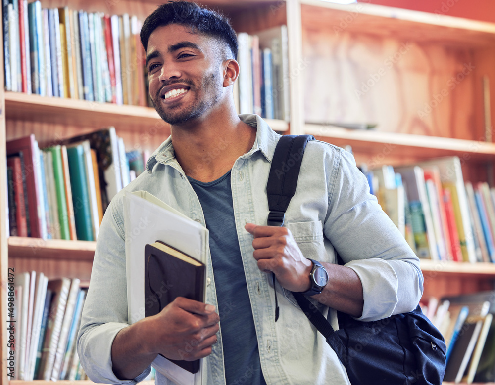 Poster Get studying and go places. Shot of a young man studying in a library at university.