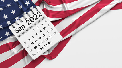 White-colored September calendar page and the American flag. Horizontal composition with copy space. Isolated with clipping path.