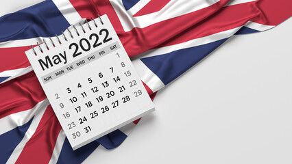 White-colored May calendar page and English flag. Horizontal composition with copy space. Isolated with clipping path.