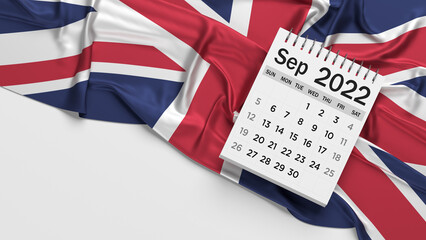 White-colored September calendar page and English flag. Horizontal composition with copy space. Isolated with clipping path.