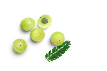 Indian gooseberry fruits (Amla, phyllanthus emblica) with green leaves isolated on white background. Top view. Flat lay.