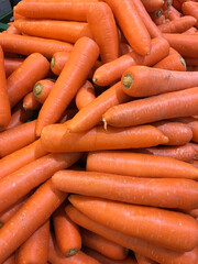 The carrots sold in the bazar market. Agriculture popular organic ingridient food texture background.