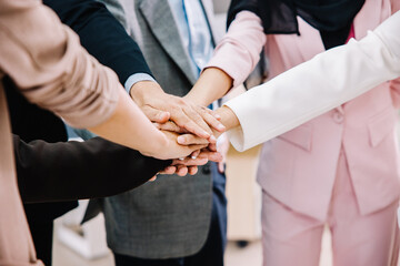 Selective focus on hands. Group business team showing unity and power with their hand's success together at the office.