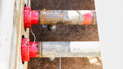 Laying of underground pipes in concrete chamber. Installation of water main at the construction...