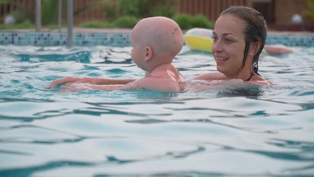 Mom and child. Little child learn to swim.