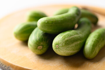 Organic cucumber on cutting wooden board, Imperfectly shape