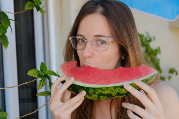 Young woman eating watermelon slice