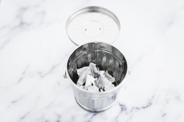 writer's block concept, garbage bin with scrunched paper inside of it