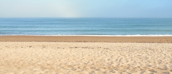 Panoramic view of the Baltic sea shore in a fog at sunrise. Beach, sand dunes. Soft sunlight. Idyllic summer seascape. Nature, environment, vacations, ecotourism, walking and exploring concepts
