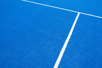 Fototapeta na wymiar partial view of a blue paddle tennis court with artificial grass