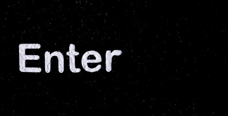 White "Enter" letter on black background