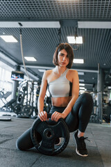 Obraz na płótnie Canvas Modern gym. Woman in sportive clothes with slim body type