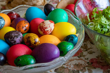Fototapeta na wymiar Table ready to celebrate Easter with traditional colorful eggs on a plate.