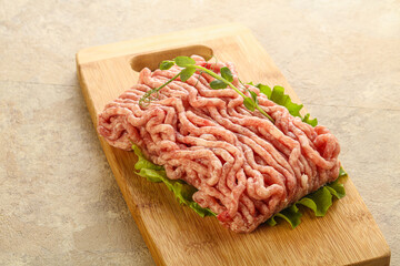Raw minced pork meat over board