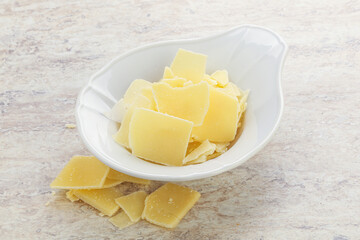 Sliced parmesan cheese heap in the bowl