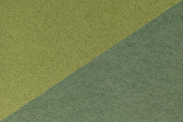 Texture of craft green and olive paper background, half two colors, macro. Structure of vintage...