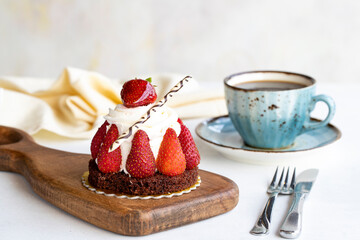 Strawberry cake. Cake filled with cream in the middle, surrounded by strawberries, on a white background. Bakery products. close up