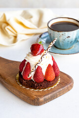 Strawberry cake. Cake filled with cream in the middle, surrounded by strawberries, on a white background. Bakery products. close up