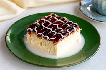 Caramel trilece cake. Trilece cake on a white background. . Bakery products. Close-up. local name trileçe pasta