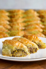 Pistachio sobiyet baklava. Pistachio baklava in plate. Traditional middle eastern cuisine flavors. Close-up.