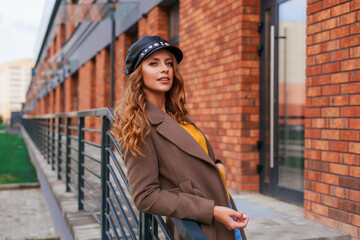 A beautiful lady in a trendy look walks in the city, spring-autumn style