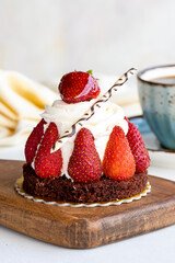 Strawberry cake. Cake filled with cream in the middle, surrounded by strawberries, on a white background. Bakery products. close up