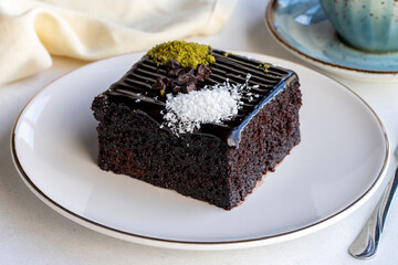 Chocolate moist cake. Wet cake in a plate. Bakery products. Close-up.