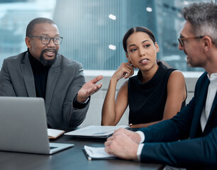 Deep in discussions. Cropped shot of a group of corporate business colleagues having a meeting around the table in the boardroom.