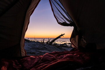 View from inside of a cozy tent to the beach and the ocean