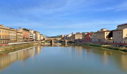 iew of the city of florence in Italy from river Arno with reflection of colorful buildings on the water