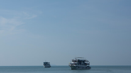 medium shot big boats on she sea sky  going to some where