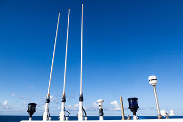 The roof of the yacht with navigational equipment against the blue sky. Antennas, radar, signal...