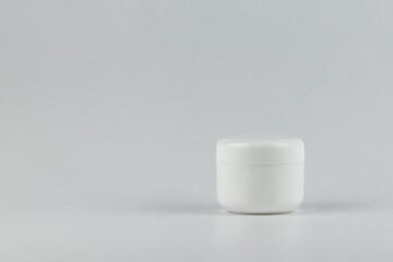 Skincare and cosmetology mockup with copy space. Unbranded plastic jar for cosmetics products. Branding identity template for text and design