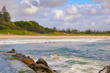 People enjoying an early morning swim at Forster Beach NSW Australia