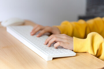 Child Hands typing on the pc keyboard. Close-up shot of kid's hands use computer keyboard.