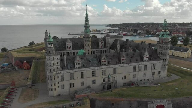 Cinematic 4K aerial drone 360 orbit shot of Kronborg Slot Castle, one of UNESCO's World Heritage sites, Helsing&oslash;r city and Marina in in Denmark