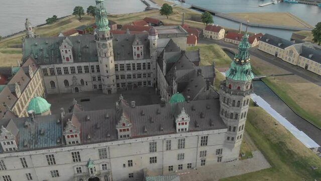 Cinematic 4K aerial drone reveal shot of Kronborg Slot Castle, one of UNESCO's World Heritage sites, Helsing&oslash;r city and Marina in in Denmark