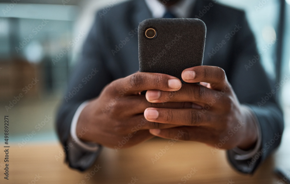 Poster texting is my cardio. cropped shot of an unrecognizable businessman using a cellphone in an office.
