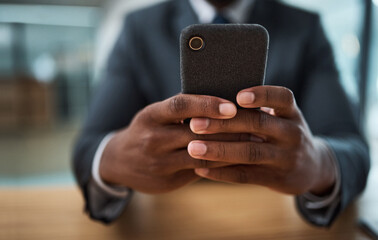 Texting is my cardio. Cropped shot of an unrecognizable businessman using a cellphone in an office.