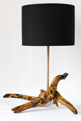 Fototapeta premium Unique handmade table lamp from sea driftwood isolated on white background