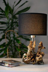 Unique handmade table lamp made of driftwood in the interior
