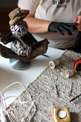 craftswoman collects a handmade floor lamp. business woman concept