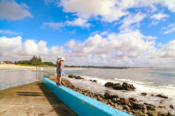 Elderly couple enjoying the view from the edge of the Ocean Baths at Forster NSW Australia