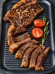 Grilled top sirloin or cup rump beef meat steak on black board. Dark background. Picanha steak