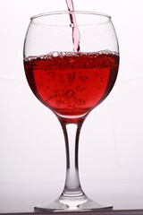 a glass with a red wine on a white background