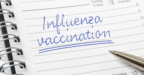 Influenza Vaccination written on a calendar page