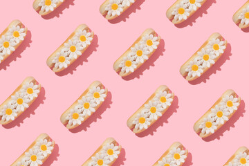 Spring creative pattern with white flowers in hot dog bun pastel pink background. 80s or 90s retro fashion aesthetic bloom concept. Minimal romantic food idea. - Powered by Adobe