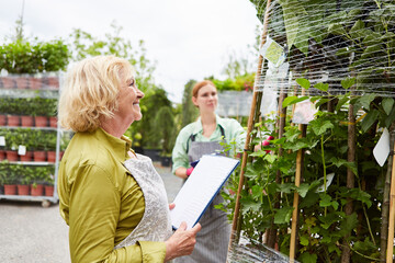 Gardener in the garden center with inventory checklist