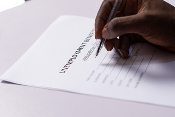 black person filling unemployment benefit form
